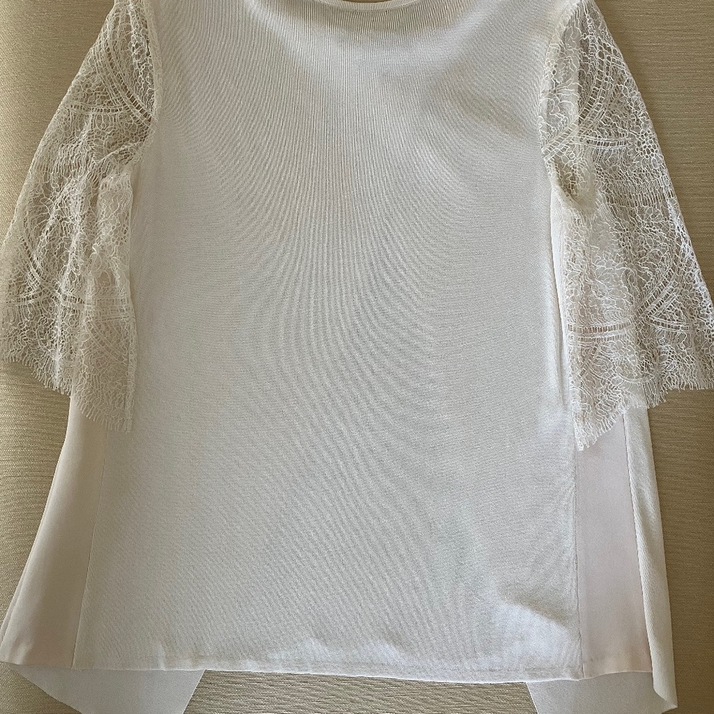 Knit ivory sweater with lace sleeves and back panel.